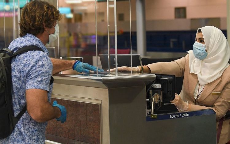 a woman at a boarding pass counter