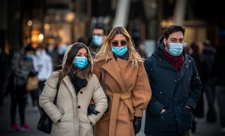 people wearing masks walking on the streets